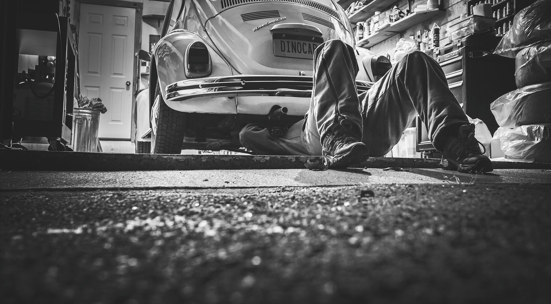 Mechanic working under a vehicle in the shop